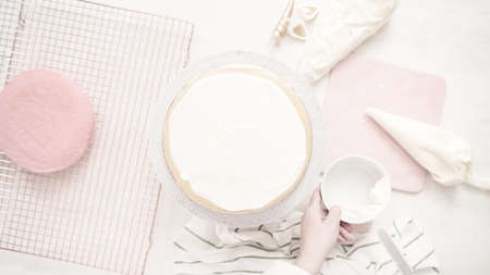 Flat lay. Assembling pink and purple cake layer to make unicorn cake for little girl's birthday party.の写真素材