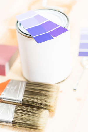 Paint swatches with purple paint sample and metal can with paint.の写真素材