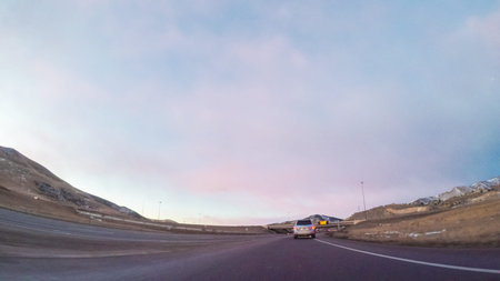 Driving on Interstate highway I70 in the mountains at sunrise.