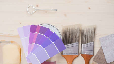 Metal paint can with purple paint and other paint tools for home improvement project.の写真素材