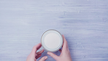 Metal paint can on painted background.