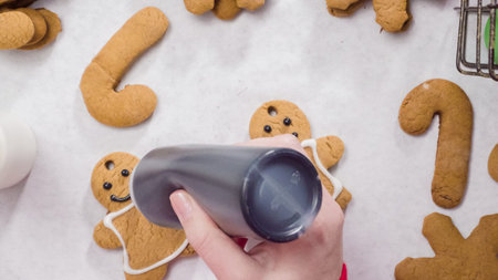 Decorating gingerbread cookies with royal icing for Christmas.