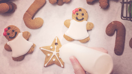 Decorating gingerbread cookies with royal icing for Christmas.