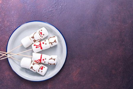 Flat lay. Marshmallow snowmen and raindeer on sticks for hot chocate drink.の写真素材