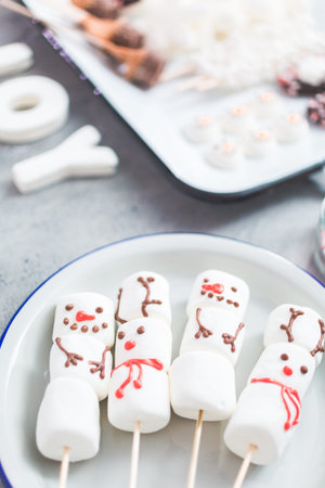 Close up view. Marshmallow snowmen and reindeer on sticks for hot chocate drink.の写真素材