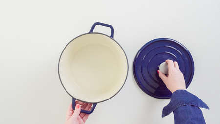 Brand new enameled cast iron covered dutch oven on a white background.の写真素材