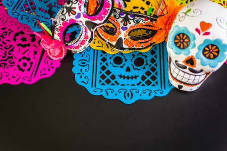 Decorations for traditional Mexican holiday Day of the Dead on a black background.