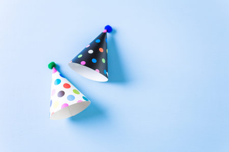 Colorful party hats for kids Birthday Party on blue background.