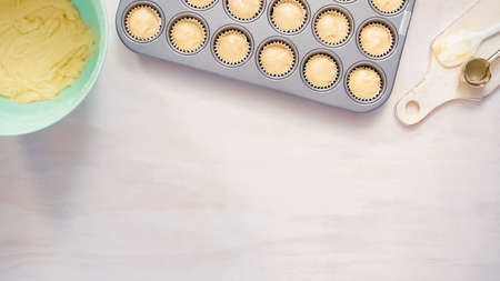 Flat lay. Scooping vanilla cupcake batter into cupcake liners.の写真素材