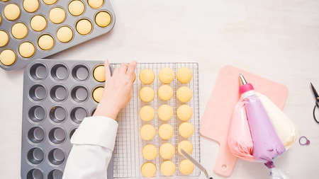 Flat lay. Freshly baked small vanilla cupcakes.の写真素材