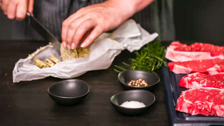 Raw New York strip steaks on a wood cutting board.の写真素材