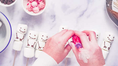 Step by step. Flat lay. Making marshmallow snowman and reindeer on sticks hot chocolate toppers for food gifting.の写真素材