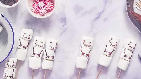 Step by step. Flat lay. Making marshmallow snowman and reindeer on sticks hot chocolate toppers for food gifting.の写真素材