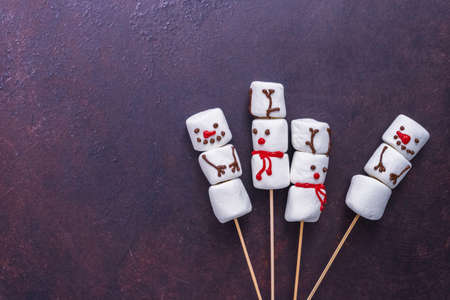 Flat lay. Marshmallow snowmen and raindeer on sticks for hot chocate drink.の写真素材