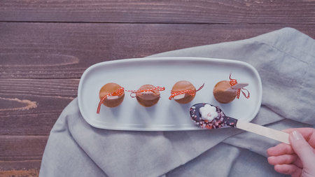 Flat lay. Salted caramel hot cocoa spoons on a white tray.の写真素材