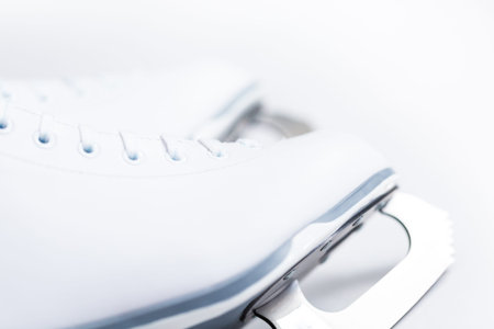 Close up view. New white figure skates on a white background.
