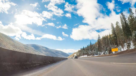 Drivign West on interstate highway I70 through the mountains.の写真素材