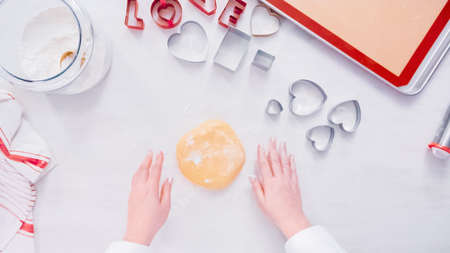 Flat lay. Step by step. Rolling sugar cookie dough with metal rolling pin.の写真素材