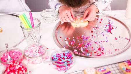 Step by step. Decorating sugar cookies with royal icing and sprinkles for Valentine's day.の写真素材