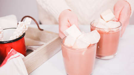 Making Amrican hot chocolate in glass cup with jumbo marshmallows.の写真素材