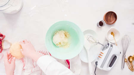 Flat lay. Step by step. Mixing sugar cookies dough in mixing bowl.の写真素材