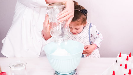 Step by step. Mixing royal icing to decorate sugar cookies.