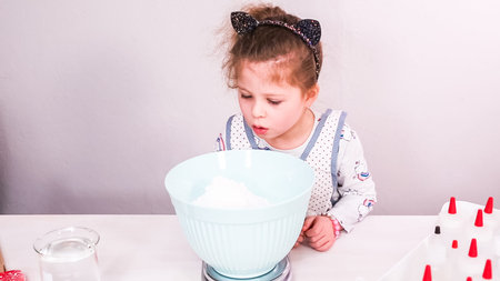 Step by step. Mixing royal icing to decorate sugar cookies.