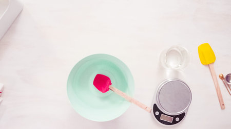 Flat lay. Step by step. Mixing royal icing to decorate sugar cookies.
