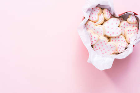 Flat lay. Heart shaped sugar cookies decorated with royal icing in gift box.の写真素材