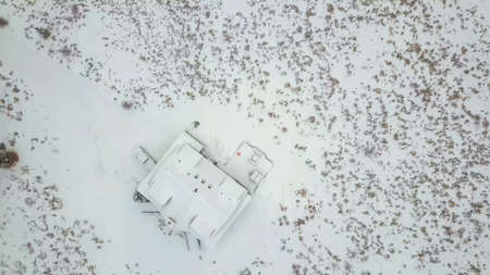 Aerial view of the mountain house covered in snow in the Winter.の写真素材