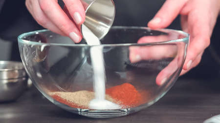 Step by step. Mixing together spice rub in glass mixing bowl.の写真素材