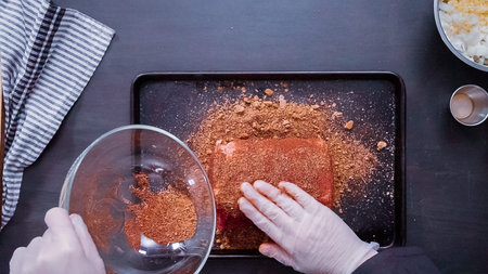 Flat lay. Step by step. Chef rubbing spices rub over boneless pork roast.