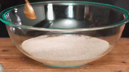 Step by step. Mixing organic ingredients in the glass bowl to bake challah.の写真素材