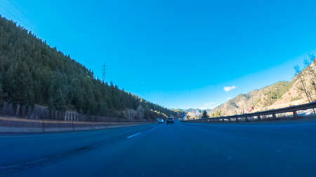 Drivign West on interstate highway I70 through the mountains.の写真素材