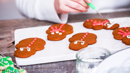 Step by step. Decorating gingerbread and sugar cookies with royal icing for Christmas.