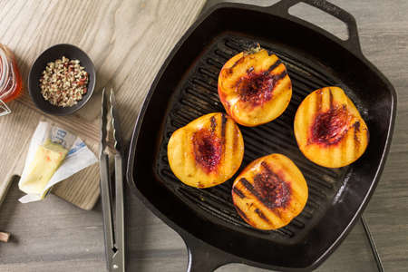 Grilled organic peachs for dessert.の写真素材