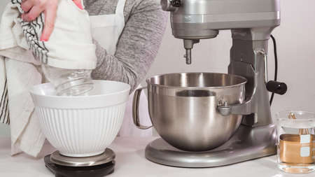 Step by step. Flat lay. Mixing royal icing in electric kitchen mixer for Easter cookies.の写真素材