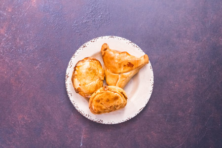 Flat lay.Homemade large empanadas with different staffings.
