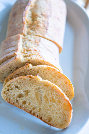Sliced ciabatta bread on a white plate.