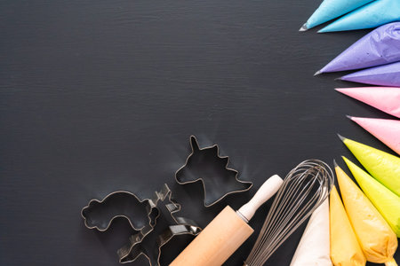 Flat lay. Variety of colors of royal icing in plastic piping bags.