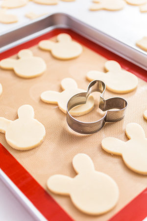 Unbaked sugar cookies on a baking sheet.