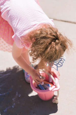 Little girl is playing hopscotch on sunny Spring daying suburbs.の写真素材