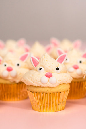 easter bunny cupcakes on pink background.
