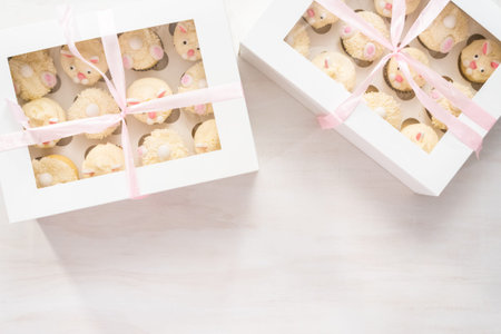 Flat lay. Easter bunny cupcakes in a white cupcake box.の写真素材