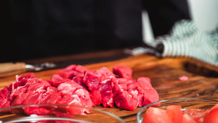 Step by step. Slicing beef into the small cubes for beet soup, borscht.の写真素材