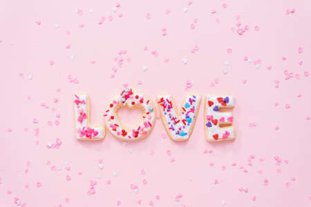Flat lay. Sugar cookies decorated with royal icing on a pink background.の写真素材