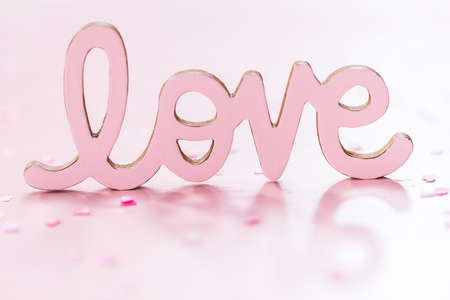 Valentine's Day LOVE sign on a pink background.の写真素材