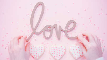 Flat lay. Valentine's Day LOVE sign on a pink background.の写真素材