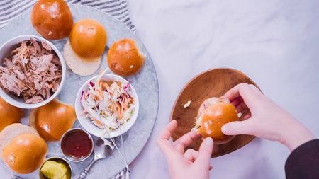Flat lay. Step by step. Making pulled pork sandwiches with coleslaw on brioche buns.