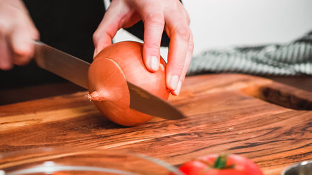 Step by step. Slicing yellow onion into the small cubes for beet soup, borscht.